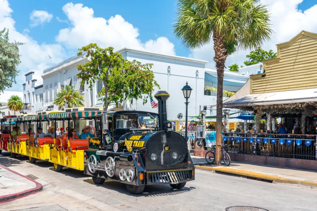 Colorful sightseeing trolley traveling through Key West, Florida