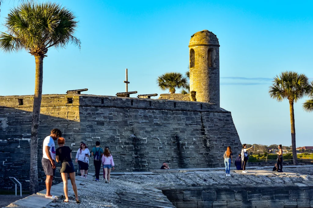 Visitors walk along the stone walls and cannons at Castillo de San Marcos in St. Augustine.